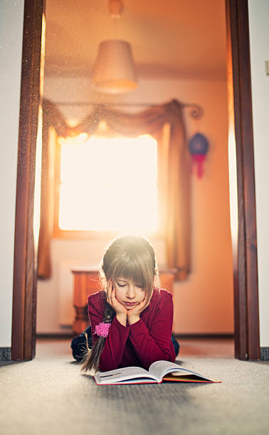 istock Beautiful little girl reading 472185511