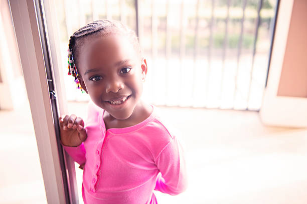 Happy Vibrant 4 Year Old Smiling This is a horizontal, color photograph of a happy black American 4 year old girl smiling at the camera. small florida home stock pictures, royalty-free photos & images