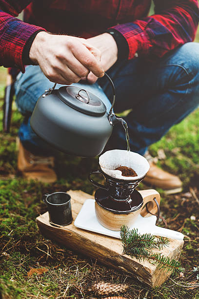 istock Man making coffee in the woods on camp 472185565