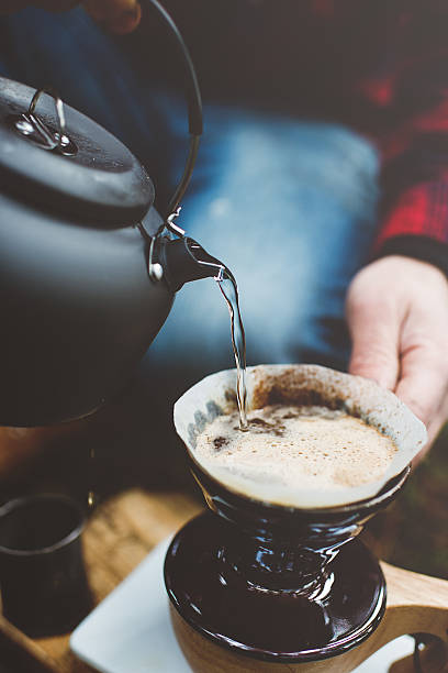 istock Man making coffee in the woods on camp 472185585