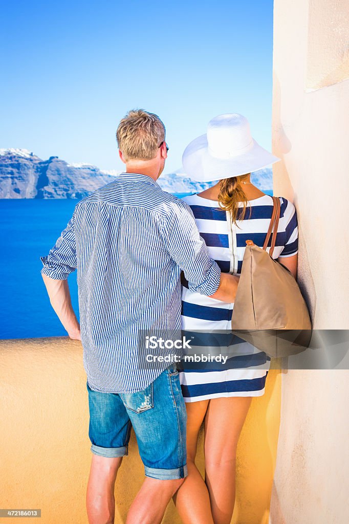 Happy young couple on Santorini island, Greece Happy young couple in village Oia on Santorini island, Greece. Click for more similar images from this session. 20-24 Years Stock Photo