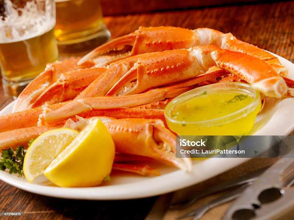 Crab Crab Claws and Legs with Garlic Butter, Lemon and a Couple of Beers -Photographed on Hasselblad H1-22mb Camera Crab Leg Stock Photo