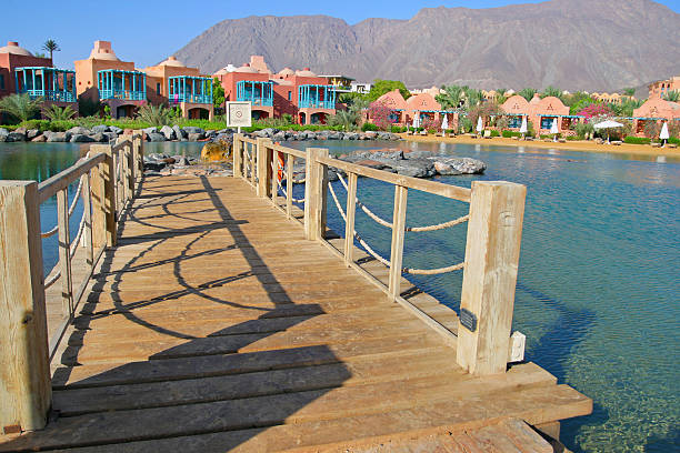 Morning resort joy Taba, Egypt - September 20, 2010: Quiet blue lagoon of hotel resort with beautiful architecture of hotel building, sunny summer morning, Taba Heights, Sinai, Egypt taba stock pictures, royalty-free photos & images