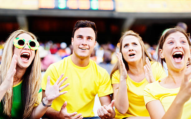 istock Involved Brazilian soccer fans watch a match with differing emotions 472189713