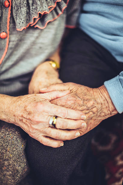 istock Senior man holding his wife's hand 472190195