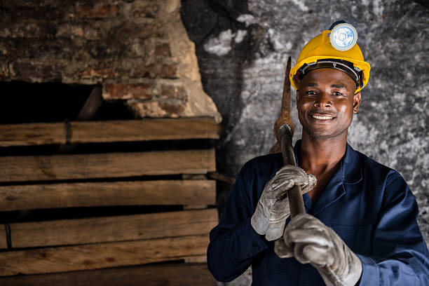 Miner holding a pick axe Miner holding a pick axe at the mine pick axe stock pictures, royalty-free photos & images