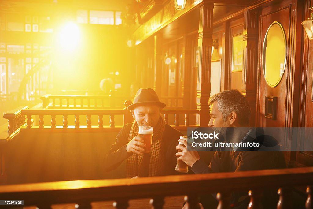 Beer Two man drink and enjoying in beer in old pub. The grain and texture added. Very shallow DOF . Pub Stock Photo