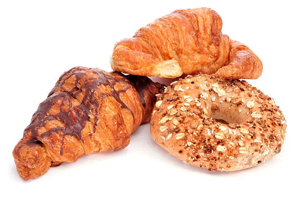 some croissants and a bagel on a white background