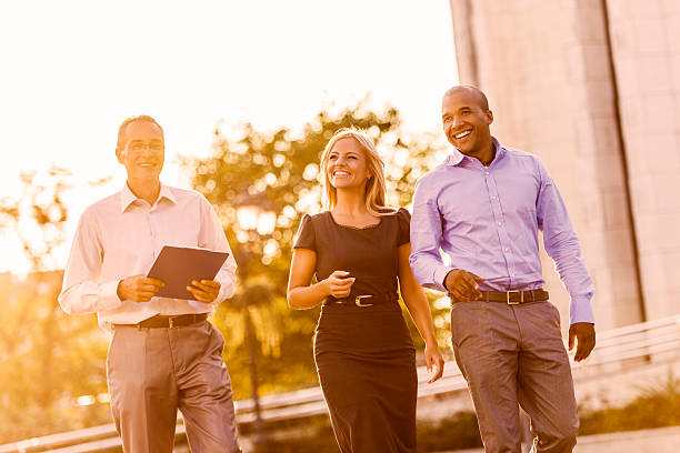 istock Three business people walking at sunset. 472193389