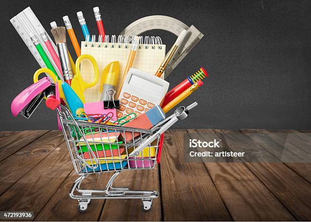 A Small Shopping Cart Filled With Back To School Supplies Stock Photo - Download Image Now