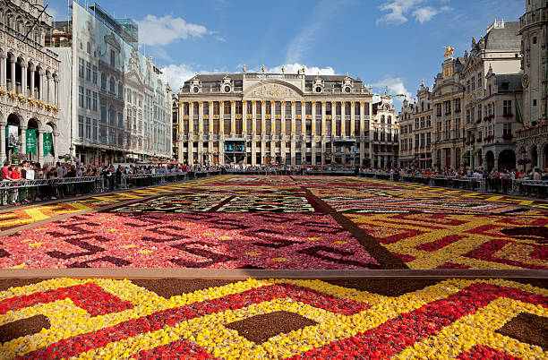 Flower Carpet in Grand Place of Brussels Against Blue Sky stock photo