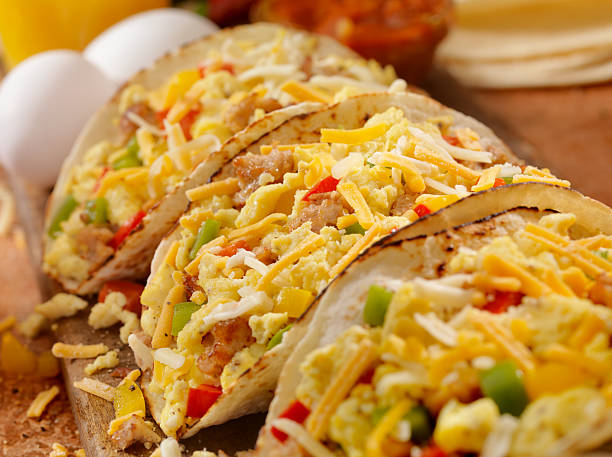Breakfast Taco Soft Breakfast Taco with Scrambled Eggs, Sausage,Peppers and Cheddar Cheese - Photographed on Hasselblad H3D2-39mb Camera mexican culture food mexican cuisine fajita stock pictures, royalty-free photos & images