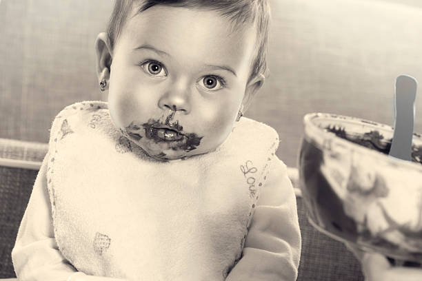 istock little baby eat chocolate 472198375