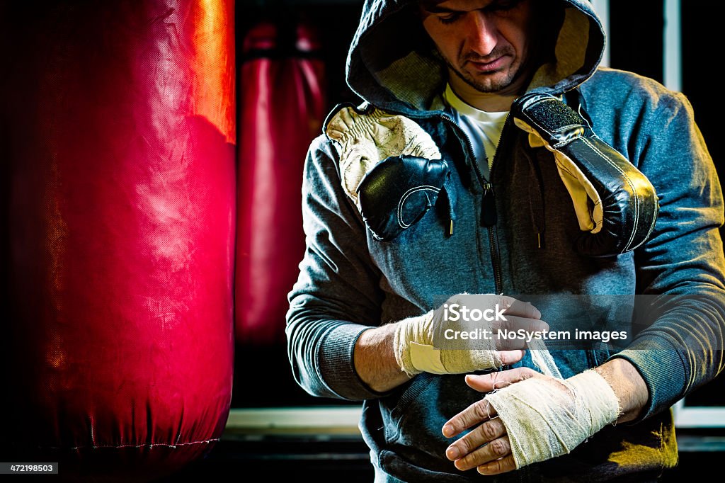 Boxer Portrait of a male boxer, bandaging hands Active Lifestyle Stock Photo