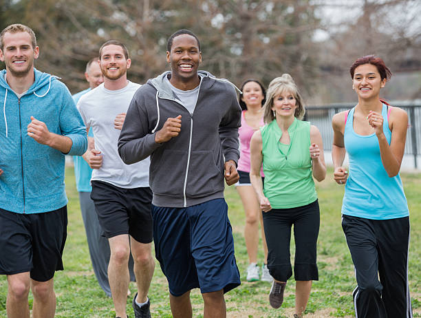 istock Group of healthy active people running together in park 472199105