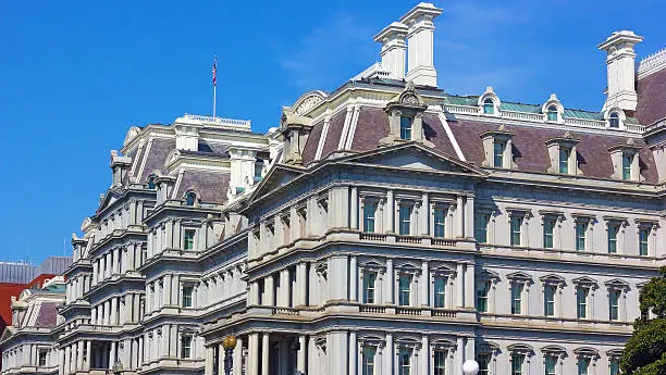 Old Executive Office Building under a clear blue sky.