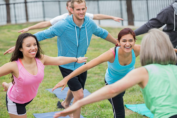 istock Happy group of fit people stretching together during exercise class 472200165