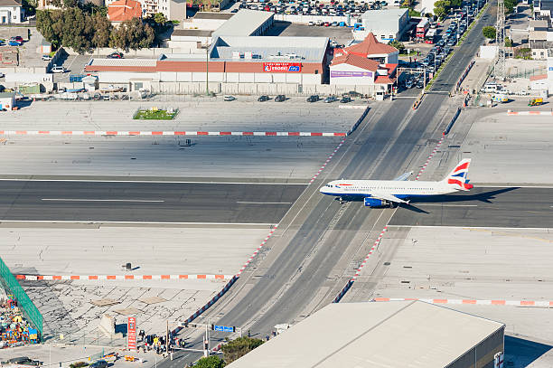 Gibraltar, Gibraltar - December 29, 2012: British Airways Plane moments before taking off from Gibraltar Airport, one of the shortest runways in the world. The runway and road intersect, so normal traffic has to be halted when planes take off.