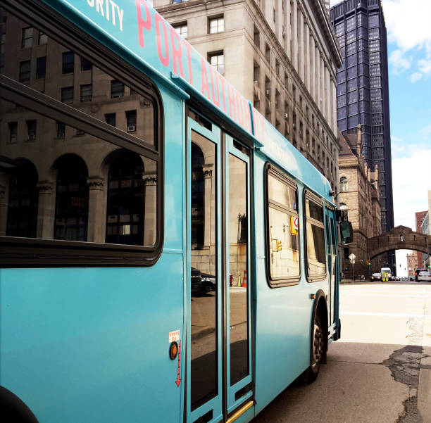 Green electric bus in the city, bus transportation on the city road.