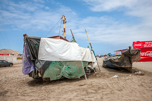 San Pedro, Peru - January 18, 2015: Boats and beach cafe at the beach on Peruvian coast at San Pedro south of Lima