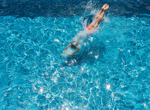 Young Man Diving Into A Pool