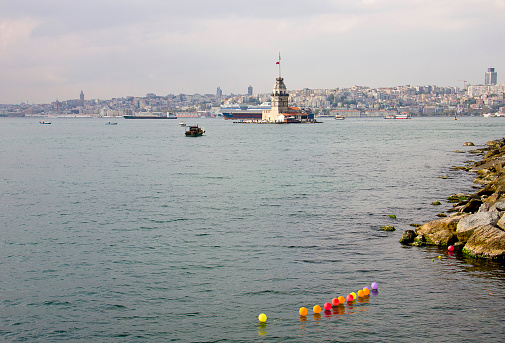 Istanbul, Turkey - October 6, 2014: Balloons view with Maiden's Tower in Istanbul, It's one of the symbols of Turkey and there is a part of the Bosphorus at the background with people. Some of people visits the restaurant in tower.