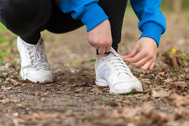 istock Woman tightening shoelaces 472203780