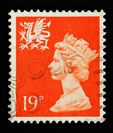 Exeter, United Kingdom - February 17, 2010: A Welsh Used Postage Stamp showing Portrait of Queen Elizabeth 2nd and welsh dragon, printed and issued between 1971and 1992