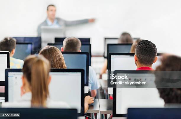 Rear View Of People On Computers In Classroom Stock Photo - Download Image Now - Computer Lab, Adult, Education