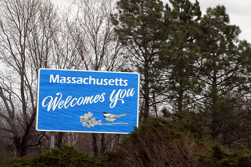 A road sign welcoming drivers to the state of Massachusetts, USA.