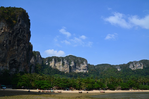 Ton Sai Beach, in Railay peninsula, a beautiful beach under huge limestone rocks and palm trees.