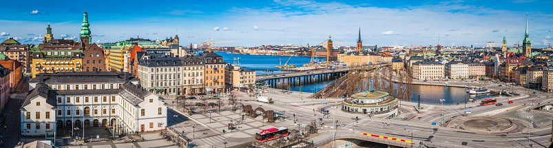 Rooftop view across the landmarks and streets of central Stockholm, from the museums and rooftops of Sodermalm, the Stadsmuseet, Sodermalmstorg and the roundabouts of Slussen, across the blue waters of Riddarfjarden to the Stadhuset on Kungsholmen, Central Station and the iconic waterfront of Gamla Stan old town. ProPhoto RGB profile for maximum color fidelity and gamut.