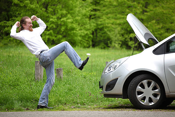 istock Driver furious a broken car by the road 472207316