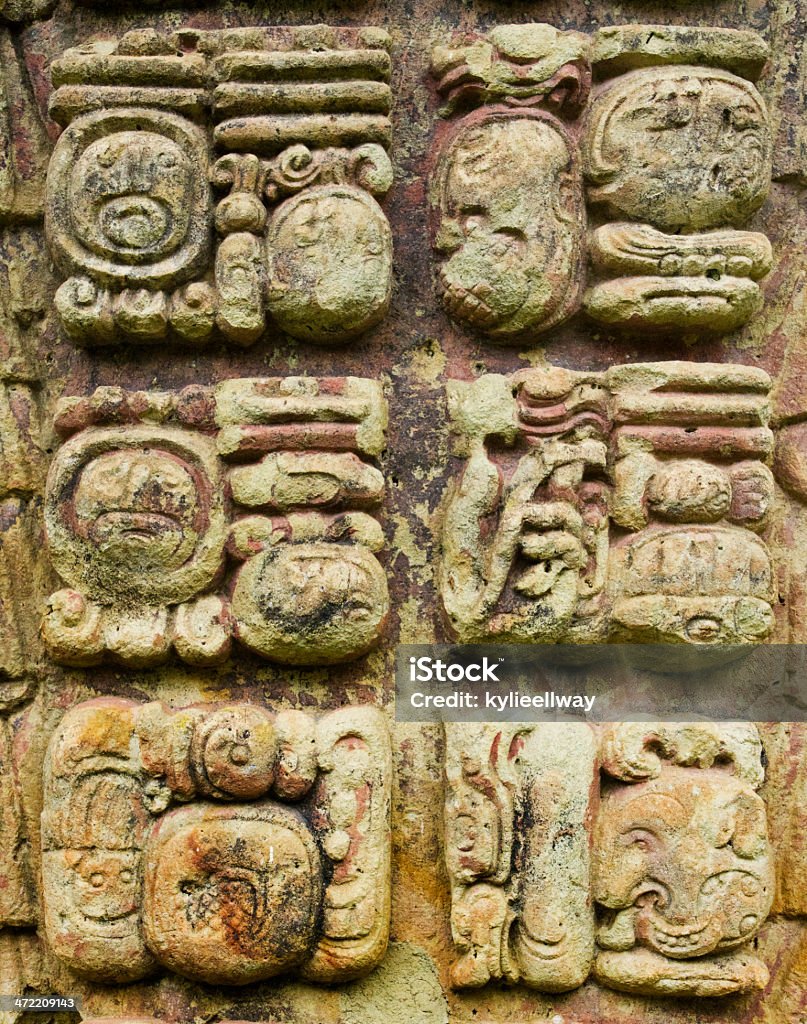 Mayan stone carved writing icons Mayan hieroglyphic writting icons in a stone stalae in Copan, Honduras American Culture Stock Photo