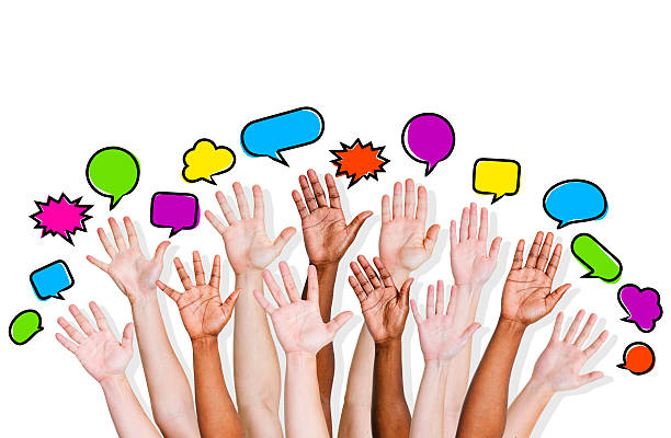 istock Group of Diverse People's Hands Raised with Colorful Speech Bubble 472210183