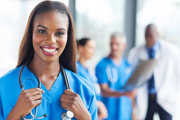 istock Smiling female nurse with stethoscope around her neck 472210709