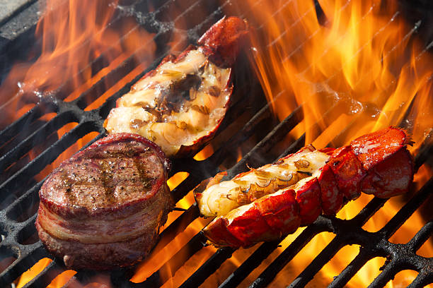 istock Bacon Wrapped Beef Filet Mignon and Grilled Lobster Tails, Flame 472211094