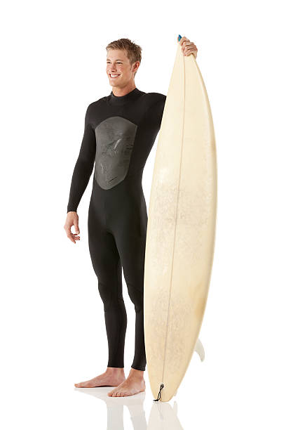 istock Smiling male surfer holding surfboard 472214620
