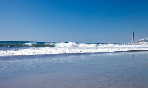 istock Lighthouse at the end of beach 472214703
