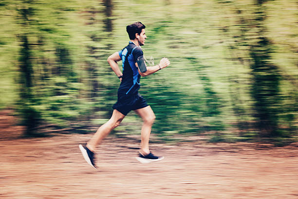 istock Young man running outdoors in the park 472215132