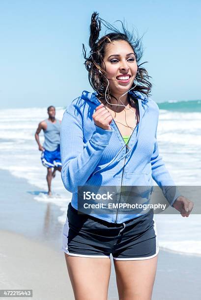 Young Hispanic Woman Jogging On Vero Beach Stock Photo - Download Image Now - Breaking Wave, Surfing, Vero Beach