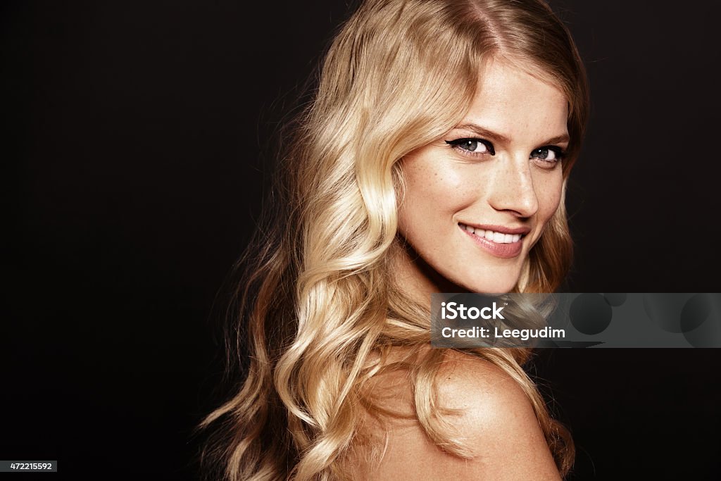 smiling woman close-up portrait of smiling young woman with curly blond hair Women Stock Photo