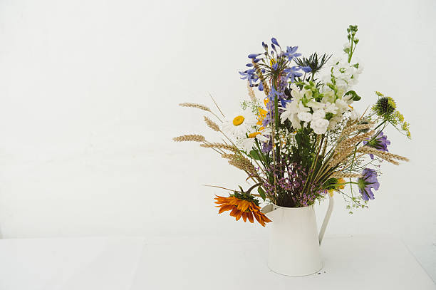istock Bunch of wild flowers in jug on white 472218183
