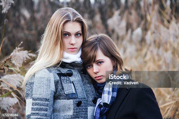 Two Young Pensive Beautiful Women Stock Photo - Download Image Now - 20-24 Years, 20-29 Years, 2015