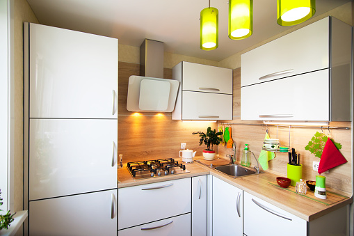 White and brown interior for small kitchen with green elements