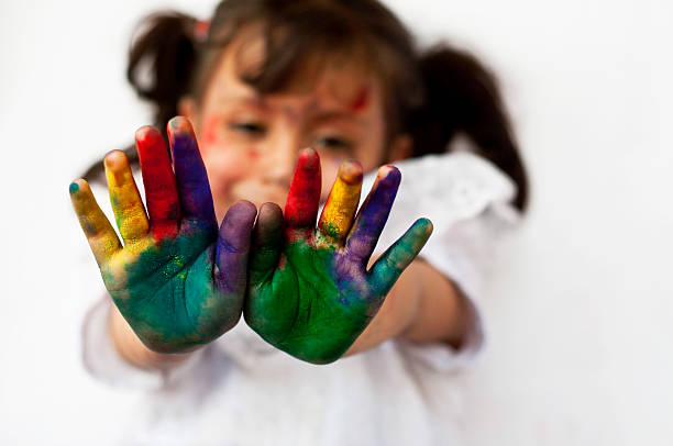 istock Small girl showing colorful hands 472220883