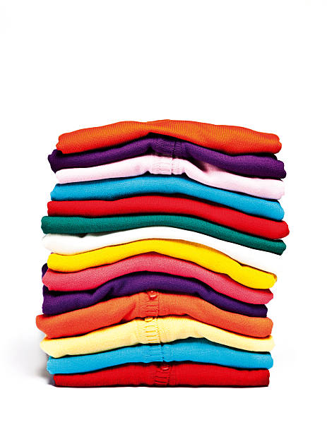 A stack of colorful clothes on a white background stock photo