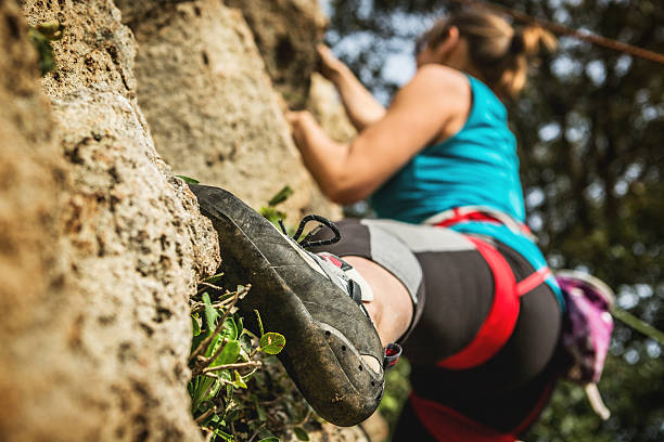 istock Female rock climber freeclimbing 472223057
