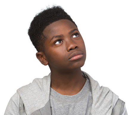 Portrait of a pre-adolescent boy, white background.