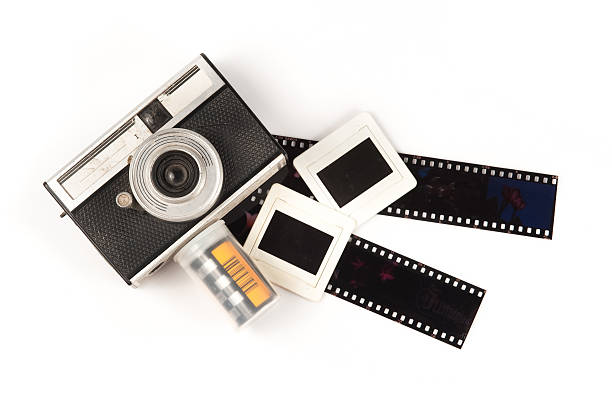 istock old camera and blank film strip on White background 472224773